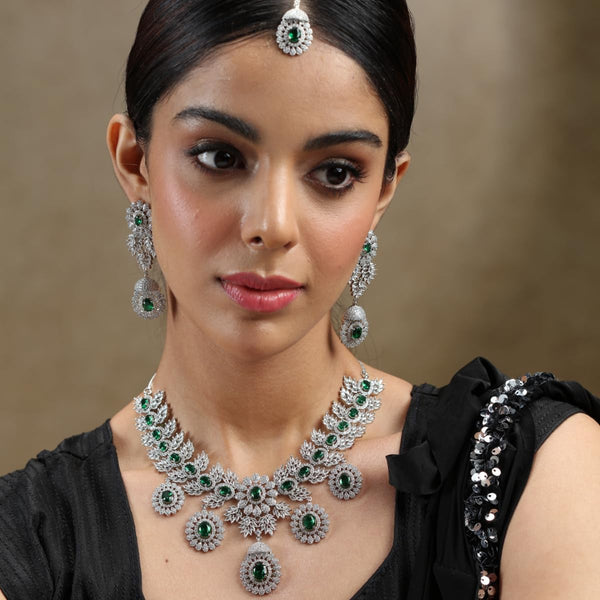 Iksava Silver Plated Green Emerald & American Diamonds Studded Statement Bridal Necklace Set with Earrings for Women